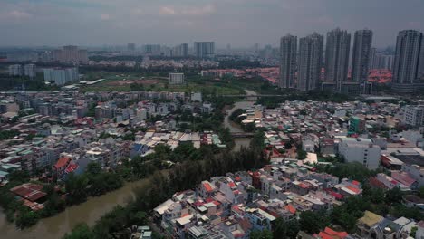 aerial suburban view on sunny day with large apartment and housing development on river-3