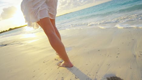 healthy caucasian female walking barefoot on the beach