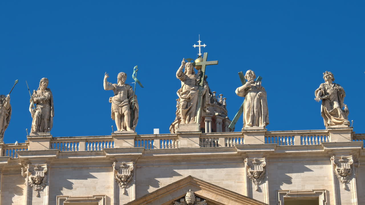 Statues on the Facade of St. Peter's Basilica on the blue sky background, in St. Peter's Square, Vatican City, Rome, Italy
