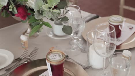 beautiful table décor and silverware set up on a dinning room table for a wedding reception dinner