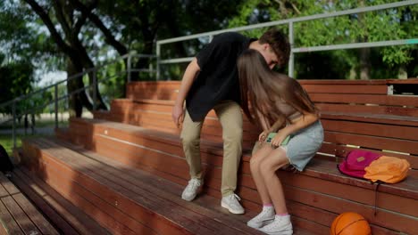 teenage couple enjoying pizza in the park