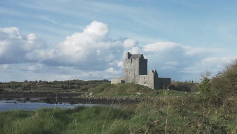 moving shot of a castle in ireland next to a bay