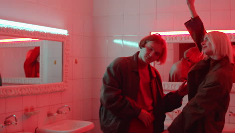 couple dancing in old fashioned bathroom with red light