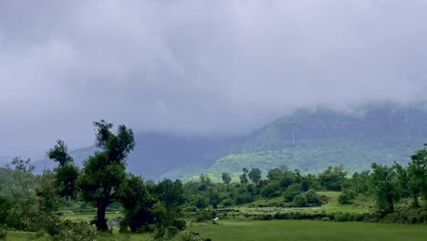 the mountains of bhandardara in maharashtra, india, are a breathtaking sight, draped in lush greenery, monsoon fog, and drifting clouds 4k