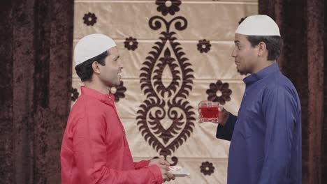 muslim men offering roohafza to friend in summers