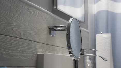 a man grabs his green toothbrush from its holder in a bathroom