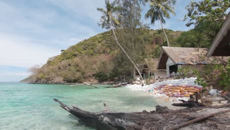 Koh-Hey-Banana-Beach-Resort-standing-nest-to-emerald-clear-shoreline---Wide-travelling-panning-shot