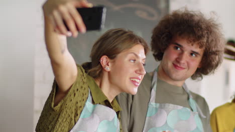 cheerful multiethnic friends taking selfie during cooking master class