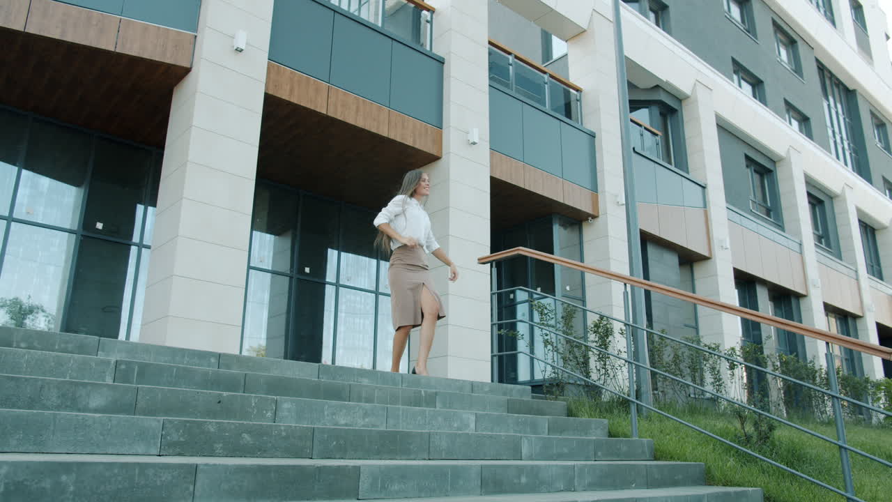 Business woman walking down stairs