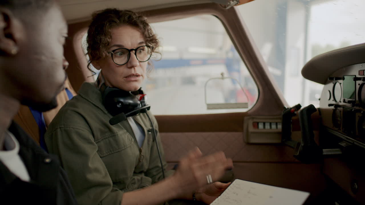 Avionics Technicians Talking inside Aircraft Cockpit during Flight Preparation