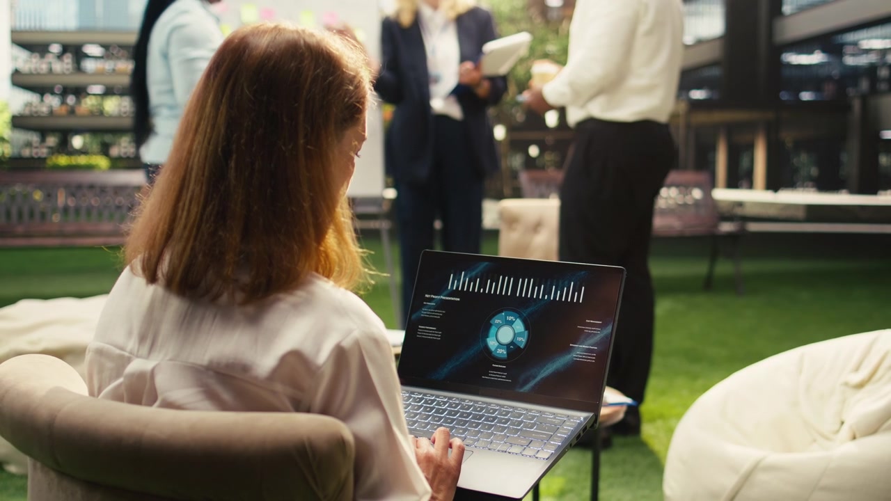 Businesswoman Working on Laptop with Data Analytics in Modern Office