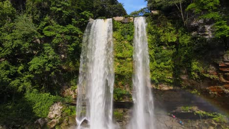 Aerial:-tropical-waterfall-cascading-over-canyon-in-rainforest,-rising-4K-shot,-Misol-Ha,-Chiapas