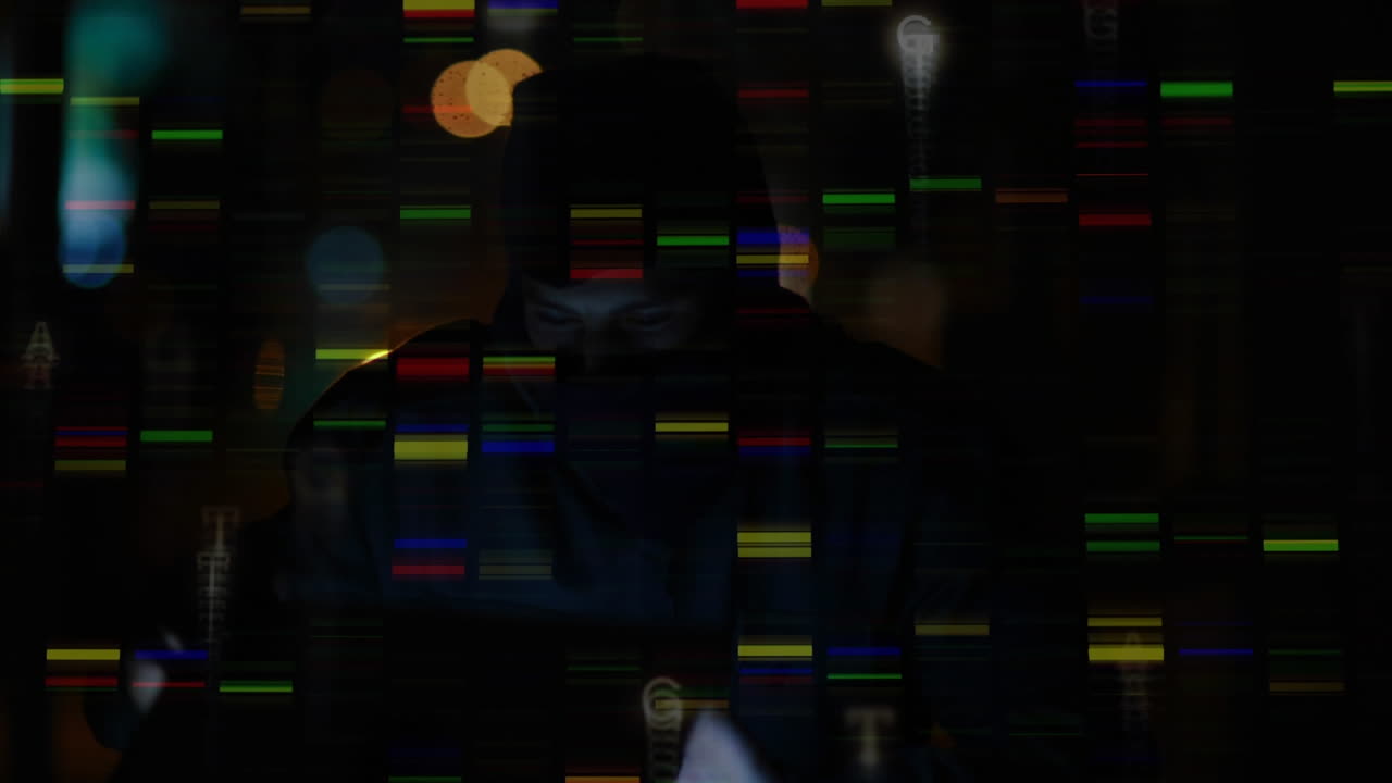 Hacker in balaclava uses laptop with colorful lights in a dark room.