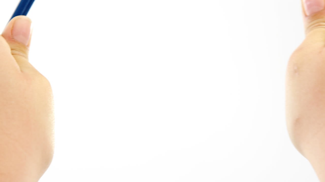 Hands breaking pencil in half on white background