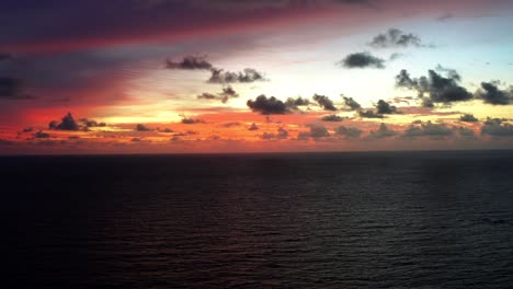 aerial drone shot of a stunning red sunrise with the vast ocean below on a warm summer morning in northern brazil near joao pessoa