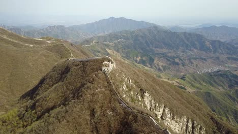 wild section of great wall of china extends into distant mountains