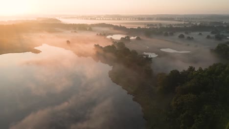 misty sunrise over lakes and forests