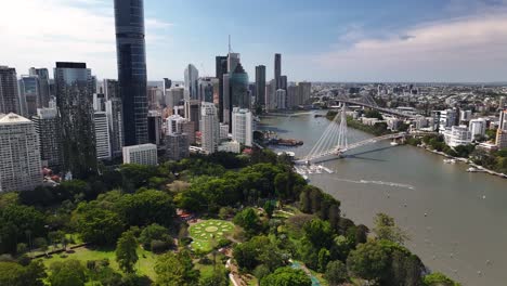 amazing brisbane cityscape over botanic garden and river. tall skyscrapers and office buildings.