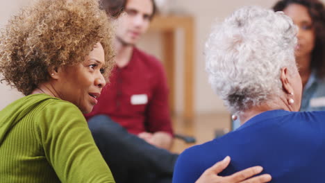 people attending self help therapy group meeting in community center