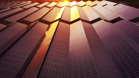 Slow-motion-aerial-of-photovoltaic-solar-power-station-technology-at-sunset