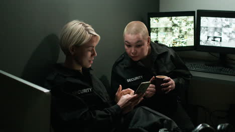 safety guards talking and using a smartphone in a room