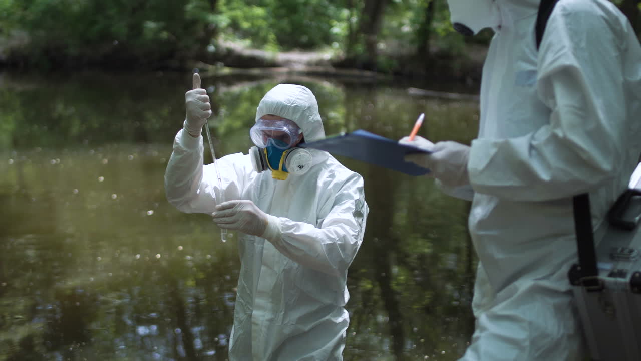 Researchers taking water samples in protective suits