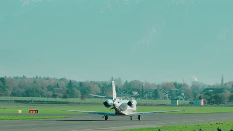 private jet taxiing at scenic austrian airport salzburg located within the mountains