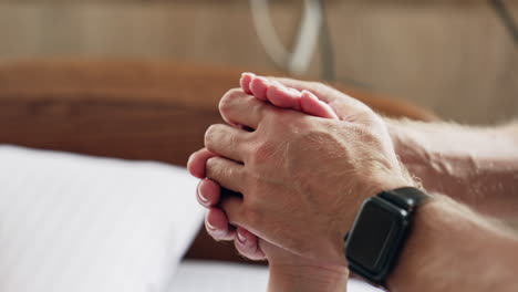 hands holding hands in hospital