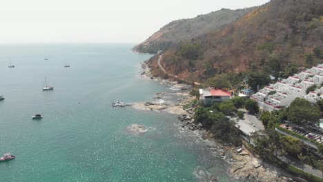 View-over-Nai-harn-Reef-and-beach-luxury-resort-in-the-tropical-landscape-of-Phuket,-Thailand---Aerial-Fly-over-shot