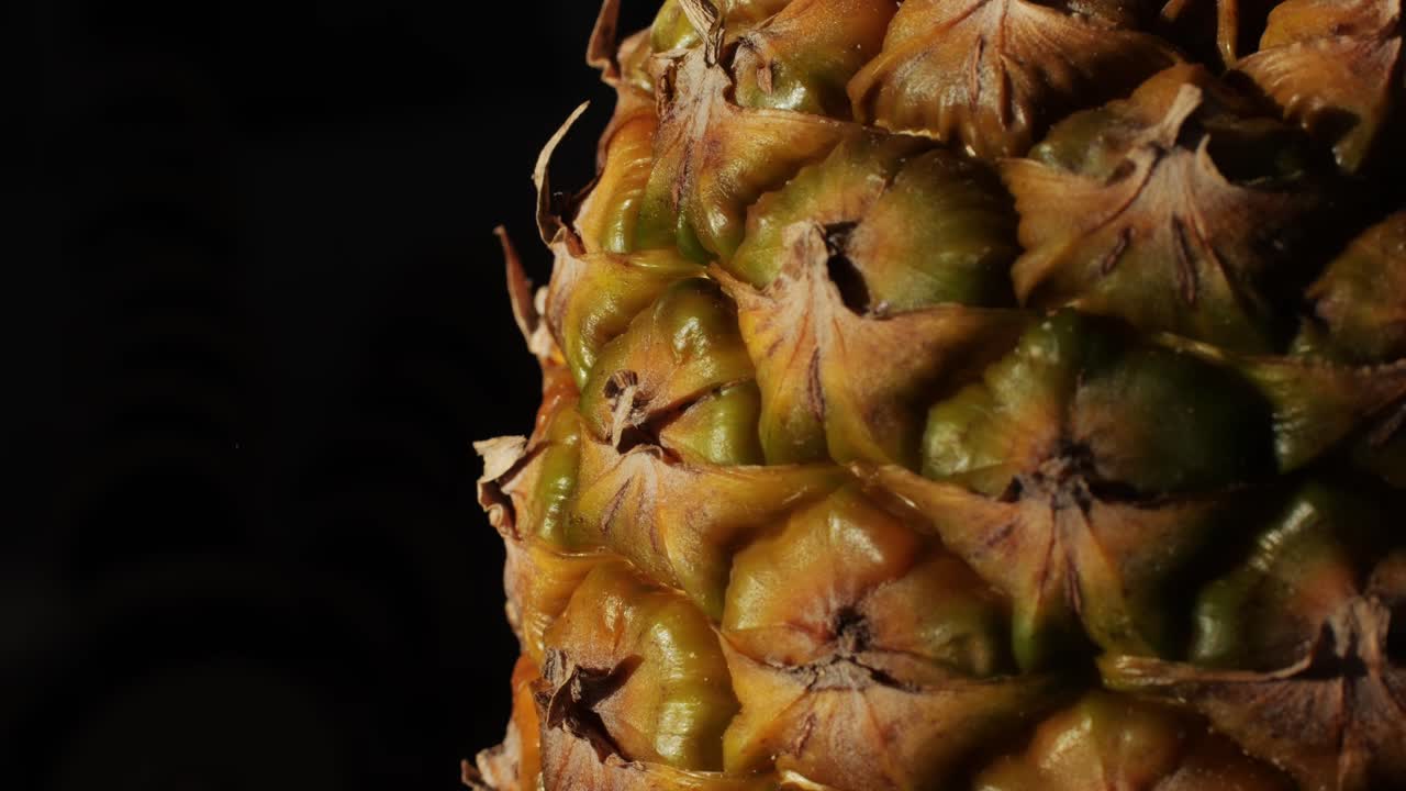 Pineapple on black background close-up macro. Fruit concept. Vitamins. High quality 4k footage
