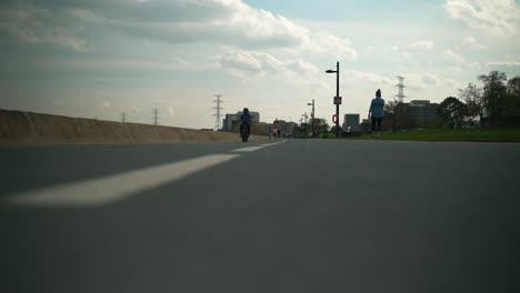 Low-angle-of-a-bike-path-as-a-cyclist-rides-by