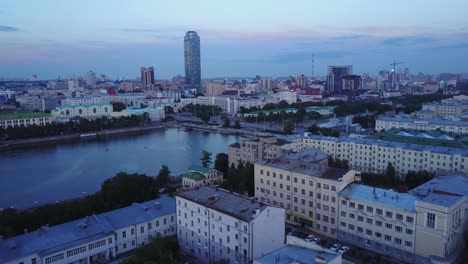 city skyline at dusk with riverfront view