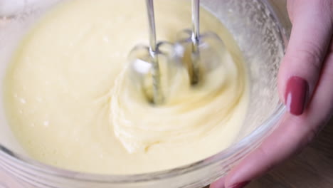 hans mixing cake batter in a bowl with mixer