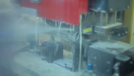 jets of cooling liquid on metal production. automated production line at factory