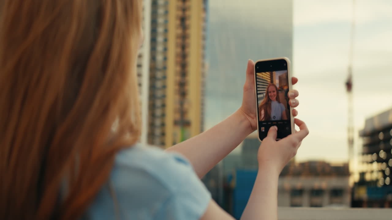 Woman taking selfie with phone