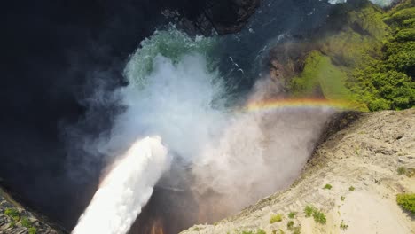 helmcken falls plunging into the murtle river with a small rainbow below in british columbia, canada