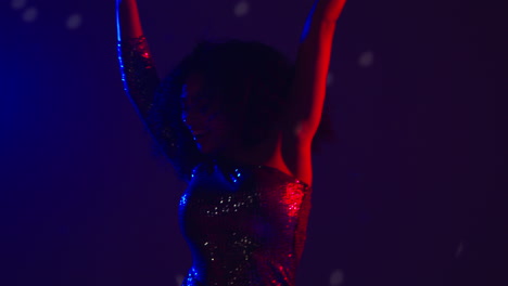 close up of woman in nightclub bar or disco dancing and having fun