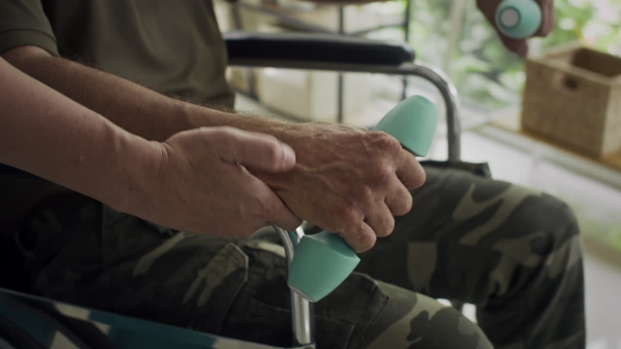 Medical Worker Supporting Injured Soldier Exercising Indoors