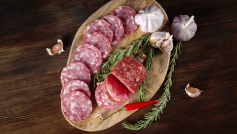 sliced salami with rosemary and garlic slowly rotates.