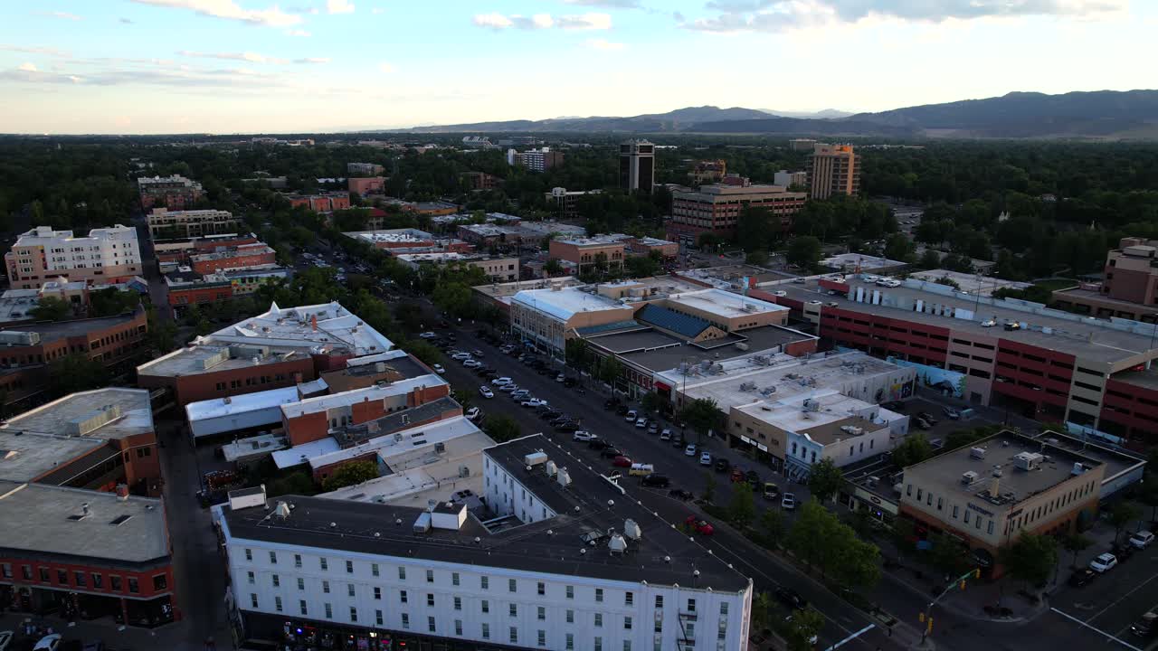 Aerial View of an Urban Area at Dusk with Distant Mountains