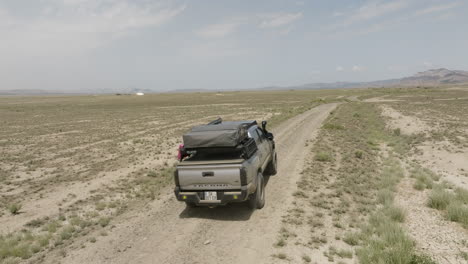 explorer jeep driving on dirt road in arid steppe, vashlovani, georgia