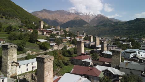 aerial view residential and caucasus mountain in background, svaneti, georgia