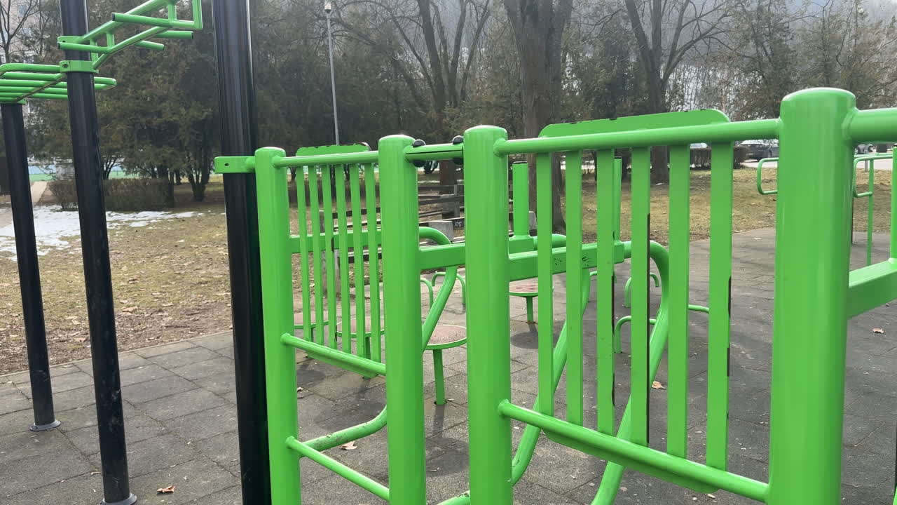 Green outdoor exercise equipment in a public park