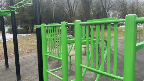 green outdoor exercise equipment in a public park