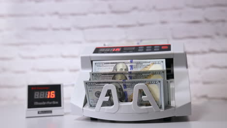 Money counting machine. Modern electronic bill counter with money, close up