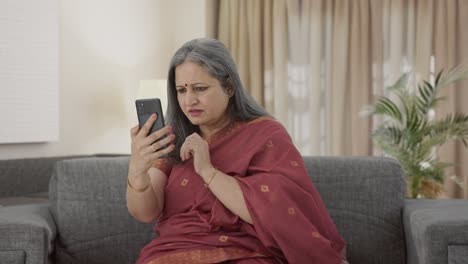 Indian-old-woman-scrolling-through-phone