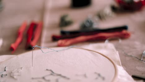 embroidery hoop with white fabric and needle