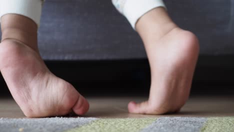 child's feet on the floor by a bed