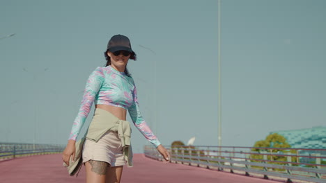 woman walking on a city bridge