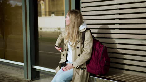 young woman sitting at bus stop